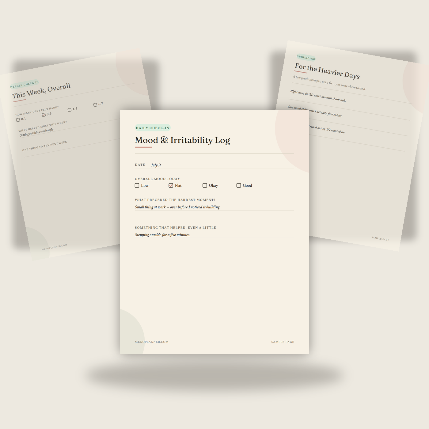 Three sample pages from the Menopause Mood & Irritability Journal fanned together, showing a daily log, weekly check-in, and grounding prompts